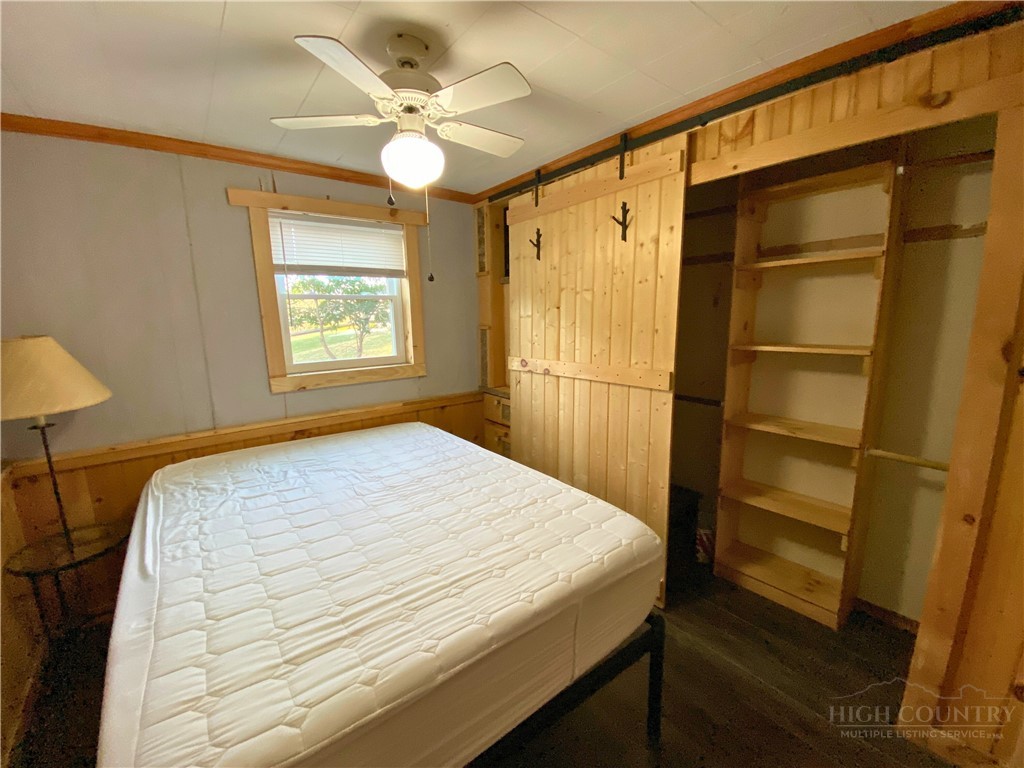 143 Ridge Crest Drive West Jefferson, NC 28694 - Photo 6 of 9 a bedroom with a bed and a chandelier