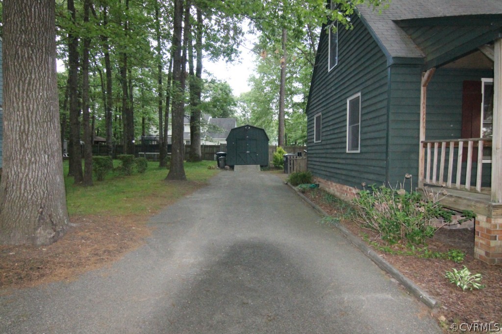 10907 Drayton Road Chester, VA 23831 - Photo 11 of 12 a backyard of a house with plants and tree