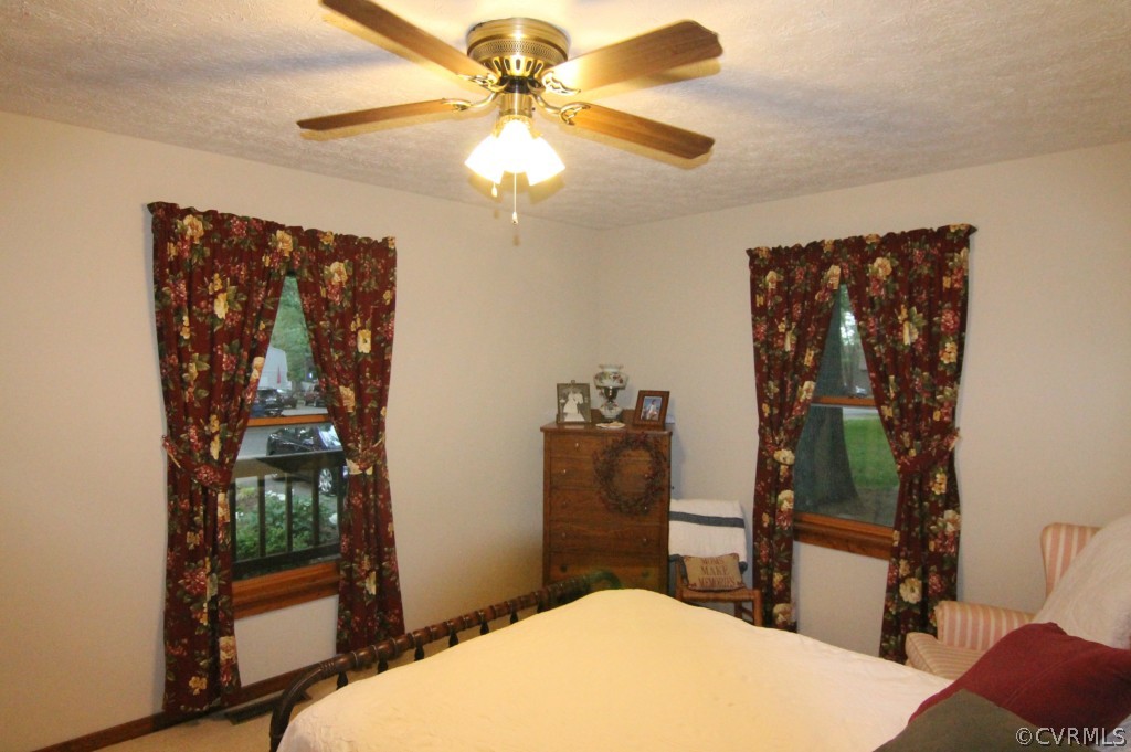 10907 Drayton Road Chester, VA 23831 - Photo 6 of 12 a bedroom with a bed and a chandelier