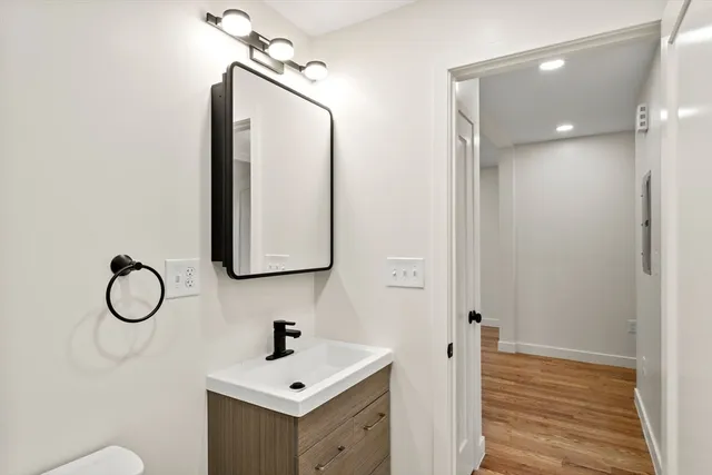 a bathroom with a sink mirror and vanity