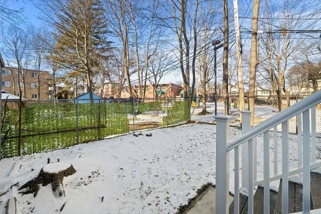 a view of a pathway of a yard with wooden fence