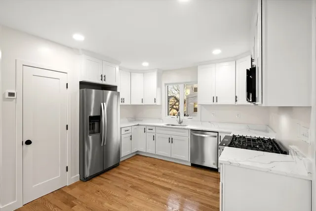 a kitchen with a refrigerator sink and stove