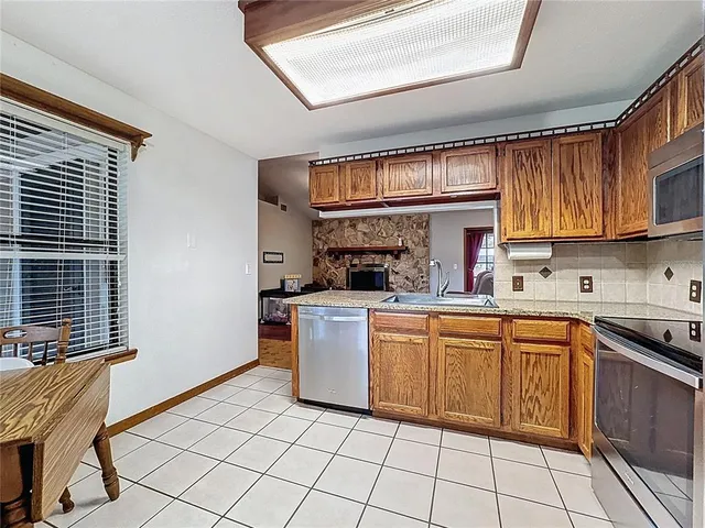 a kitchen with a sink cabinets and window