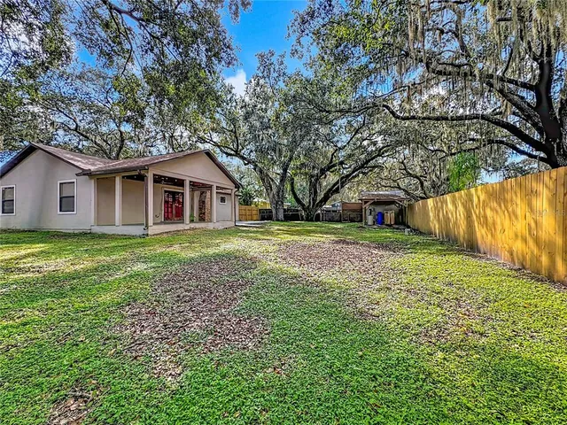 a view of house with backyard