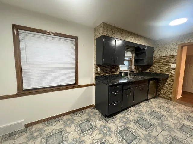 a kitchen with a refrigerator stove and sink