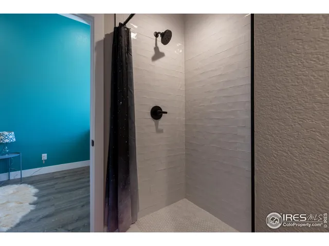 a view of a patio with table and chairs under an umbrella