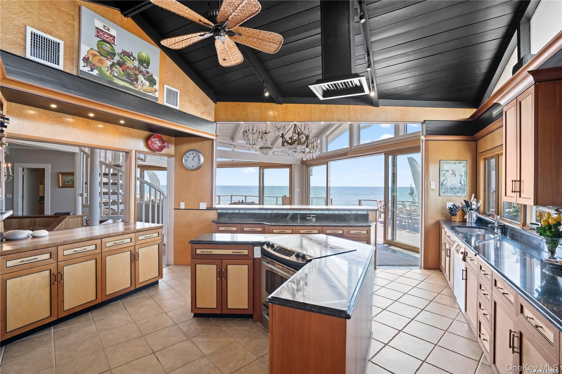 174 Dune Road Quogue, NY 11959 - Photo 13 of 35 a kitchen with stainless steel appliances granite countertop a stove and a refrigerator