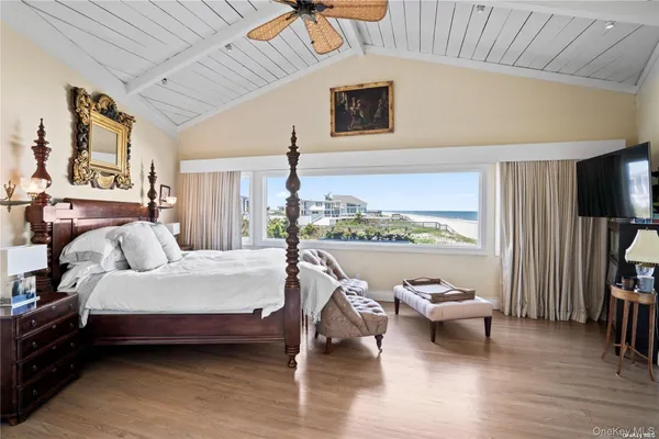 a bedroom with a bed and a large window