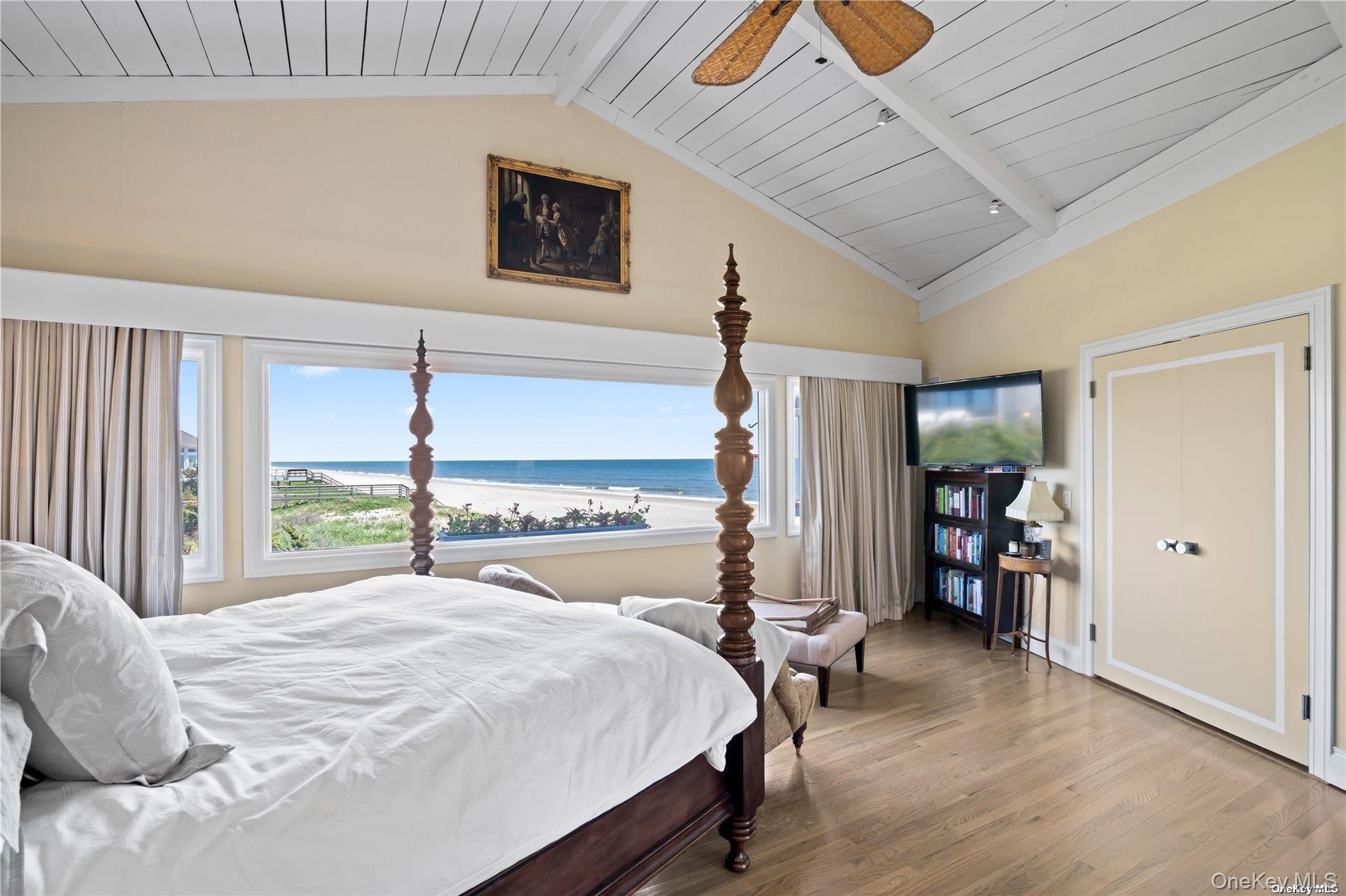 174 Dune Road Quogue, NY 11959 - Photo 15 of 35 a bedroom with a bed and a large window