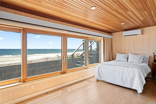 a spacious bedroom with a large bed and a large window