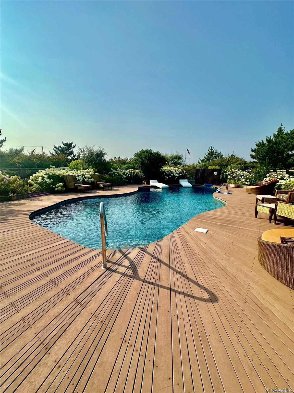 174 Dune Road Quogue, NY 11959 - Photo 35 of 35 a view of a lake with wooden floor