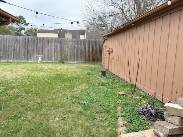 a backyard of a house with grass and plants