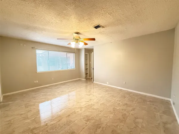 an empty room with a empty space and windows