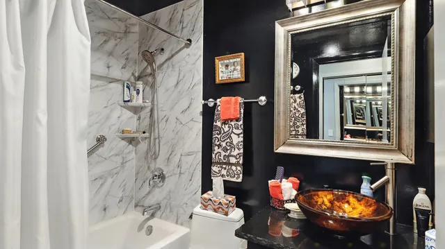 a bathroom with a toilet sink and shower