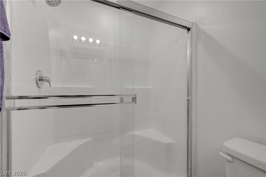 1287 Raritan Place Henderson, NV 89002 - Photo 7 of 21 A well-appointed shower stall features clear glass doors and crisp white tile walls.