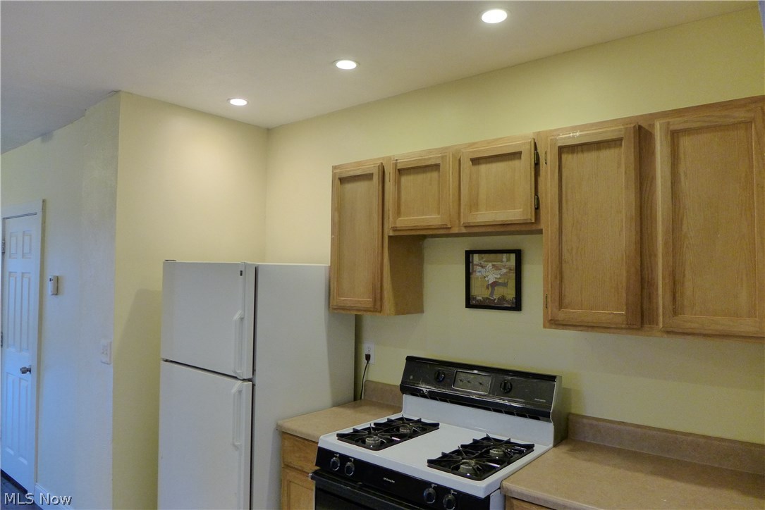 More cabinets on opposite kitchen side and prep space for cooking and preparing meals