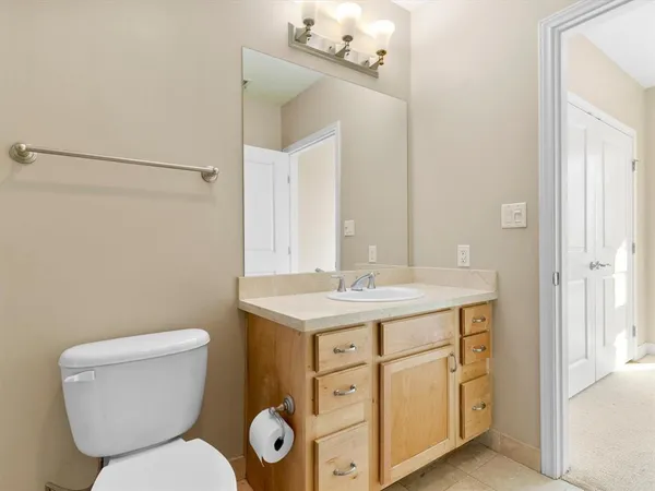 a bathroom with a toilet a sink and mirror
