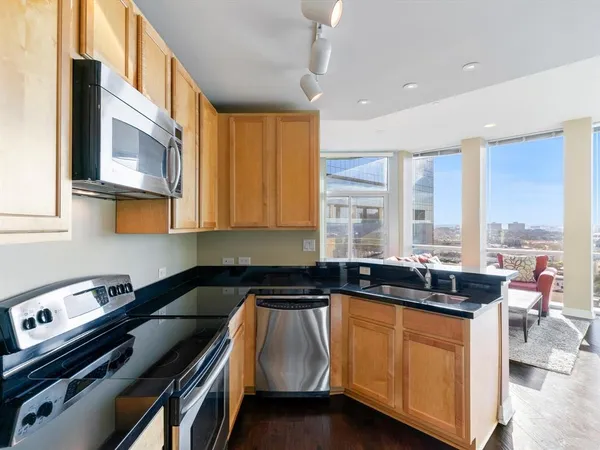 a kitchen that has a sink and a stove in it
