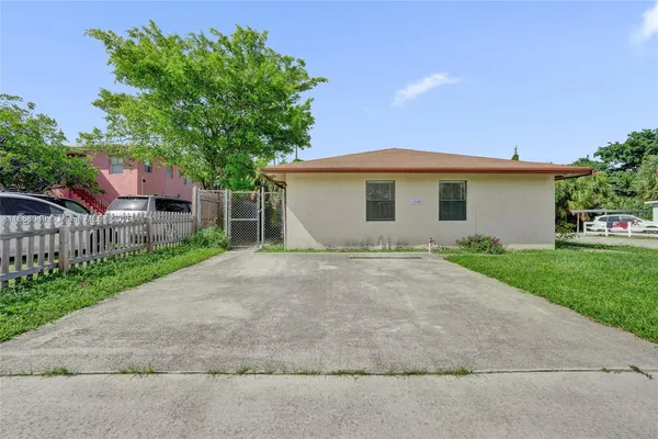 a view of a house with a yard and a garage
