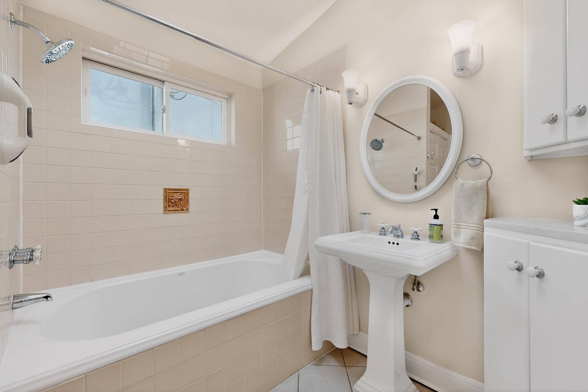 1906 Collier Street Austin, TX 78704 - Photo 20 of 40 a bathroom with a sink and a mirror