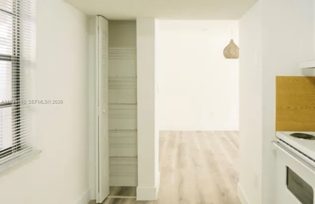 a kitchen with a refrigerator sink stove and cabinets