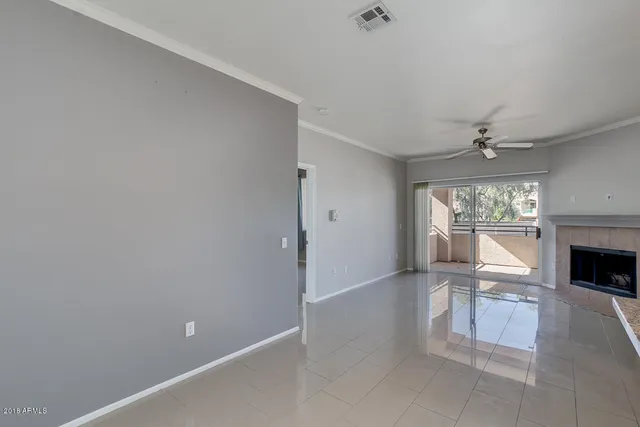 a living room with stainless steel appliances kitchen island granite countertop furniture and a fireplace