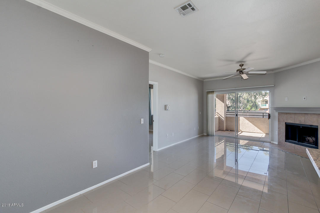 16013 South Desert Foothills Parkway, Unit 2090 Phoenix, AZ 85048 - Photo 11 of 43 a view of a livingroom with wooden floor and a fireplace
