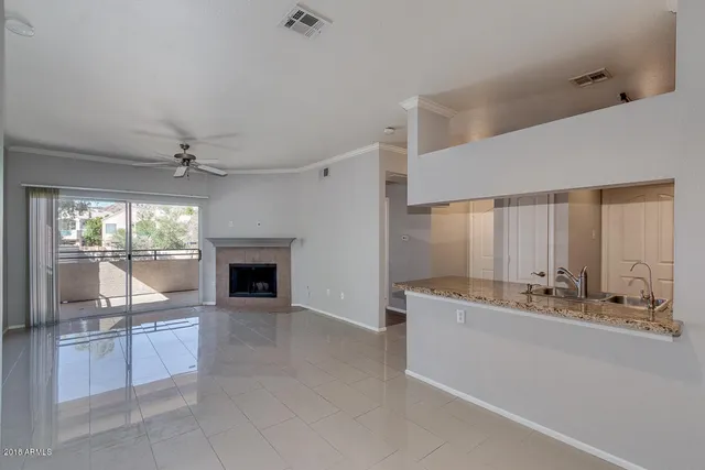 a kitchen with granite countertop a refrigerator and a sink