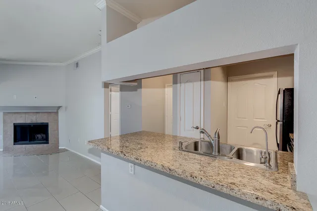 a kitchen with stainless steel appliances granite countertop a sink and a granite counter tops