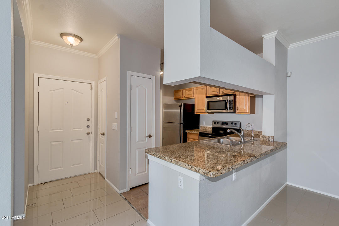 16013 South Desert Foothills Parkway, Unit 2090 Phoenix, AZ 85048 - Photo 14 of 43 a kitchen with stainless steel appliances granite countertop a sink and a granite counter tops