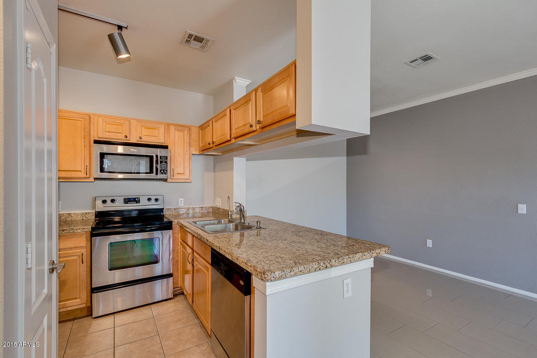 16013 South Desert Foothills Parkway, Unit 2090 Phoenix, AZ 85048 - Photo 15 of 43 a kitchen with a stove and a microwave