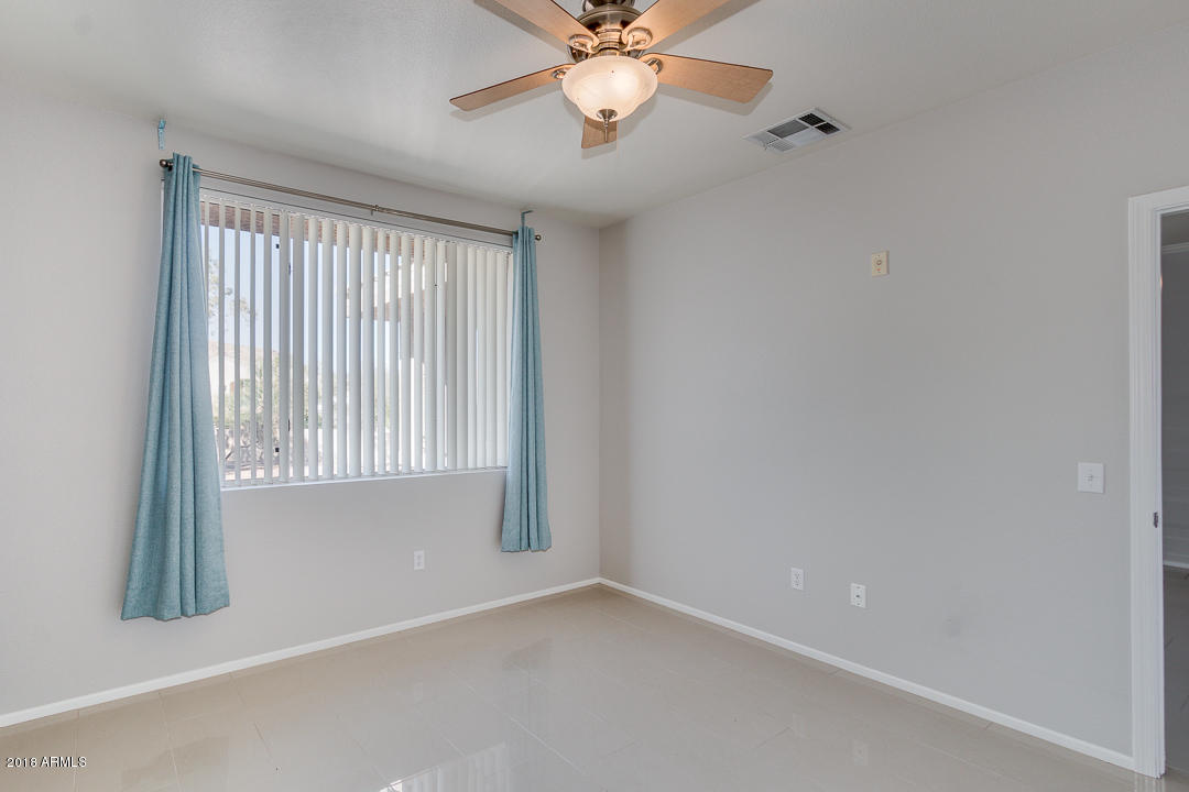 16013 South Desert Foothills Parkway, Unit 2090 Phoenix, AZ 85048 - Photo 19 of 43 an empty room with windows and fan