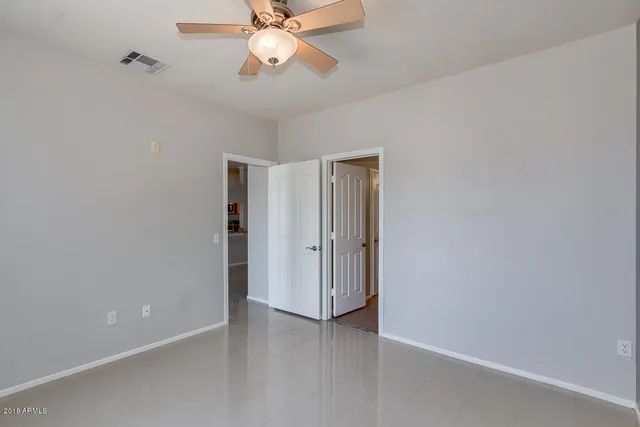 an empty room and a view of bathroom