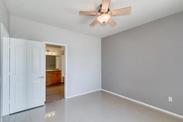 a bathroom with a granite countertop toilet sink and mirror