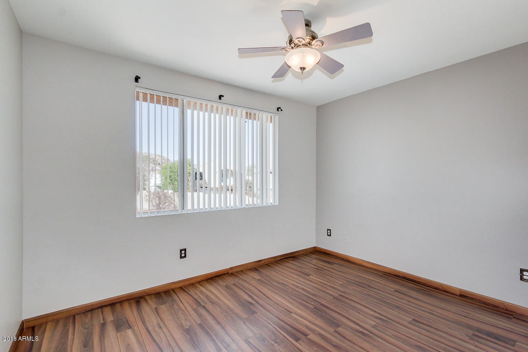 16013 South Desert Foothills Parkway, Unit 2090 Phoenix, AZ 85048 - Photo 24 of 43 wooden floor in an empty room with a window