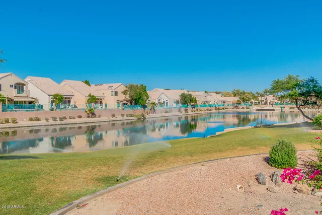 an empty room with fireplace fan and windows
