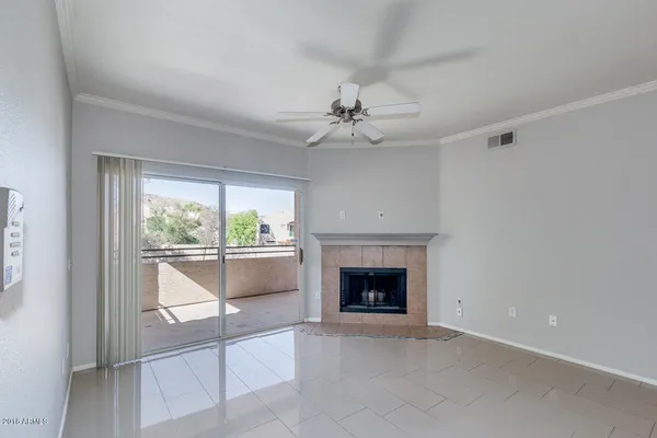 wooden floor fireplace and windows in an empty room