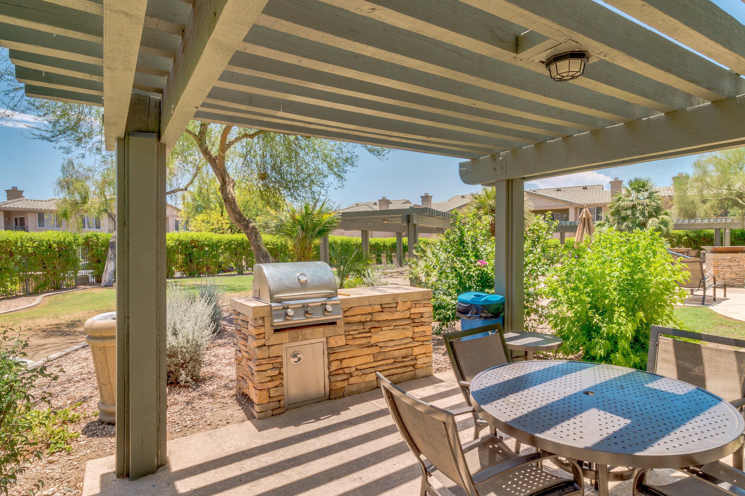 16013 South Desert Foothills Parkway, Unit 2090 Phoenix, AZ 85048 - Photo 43 of 43 a view of a patio with table and chairs and potted plants