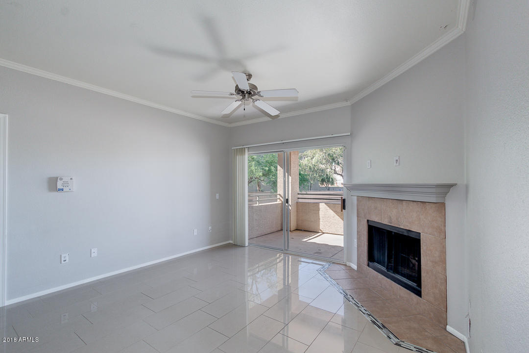 16013 South Desert Foothills Parkway, Unit 2090 Phoenix, AZ 85048 - Photo 5 of 43 wooden floor fireplace and windows in an empty room