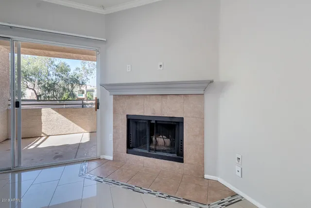 a view of kitchen with cabinets and fireplace