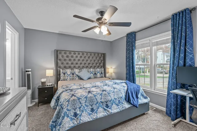 a bedroom with a large bed and a chandelier