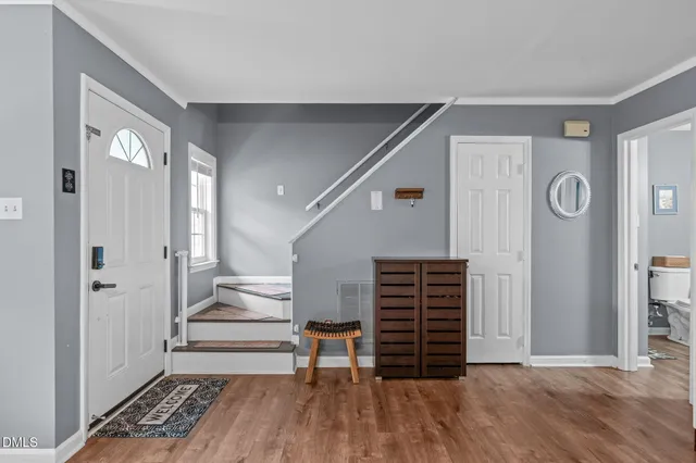 a view of entryway with wooden floor and stairs