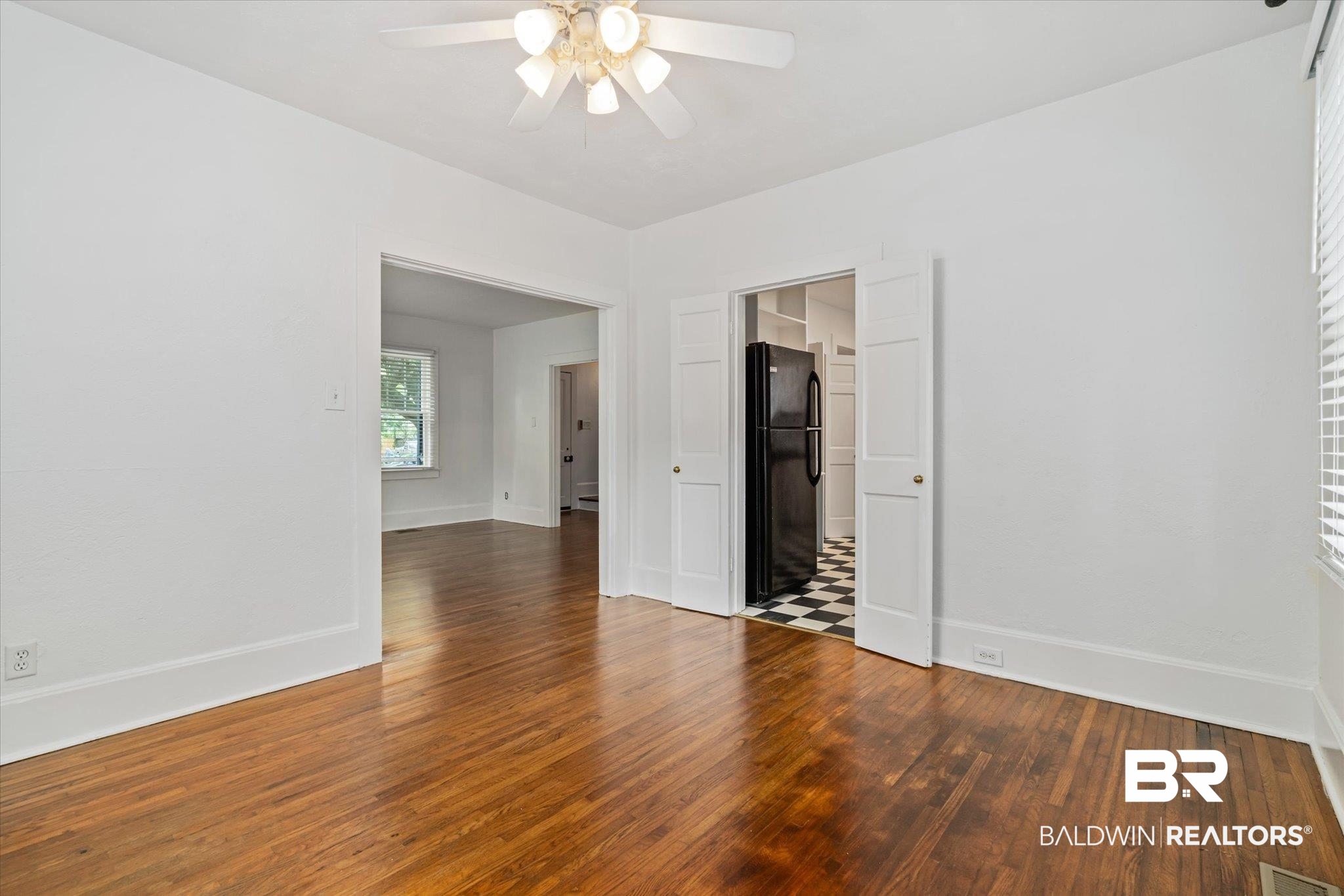 1159 Palmetto Street Mobile, AL 36604 - Photo 7 of 21 Empty room with ceiling fan and hardwood / wood-style floors