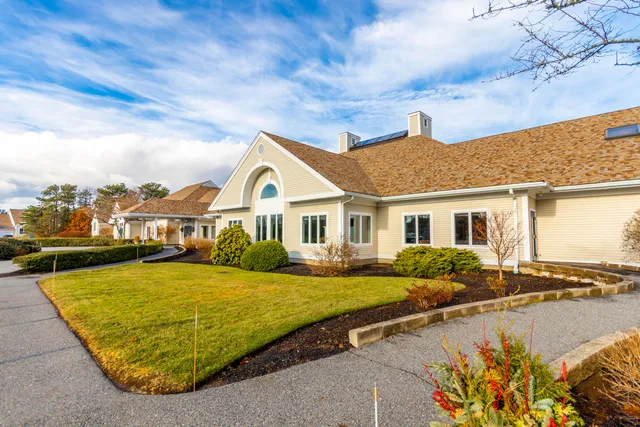 a view of a house with swimming pool and sitting area