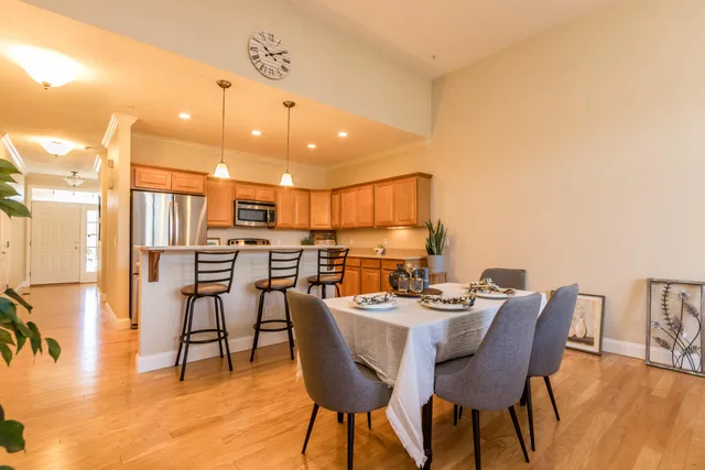 a dining room with furniture and a kitchen view