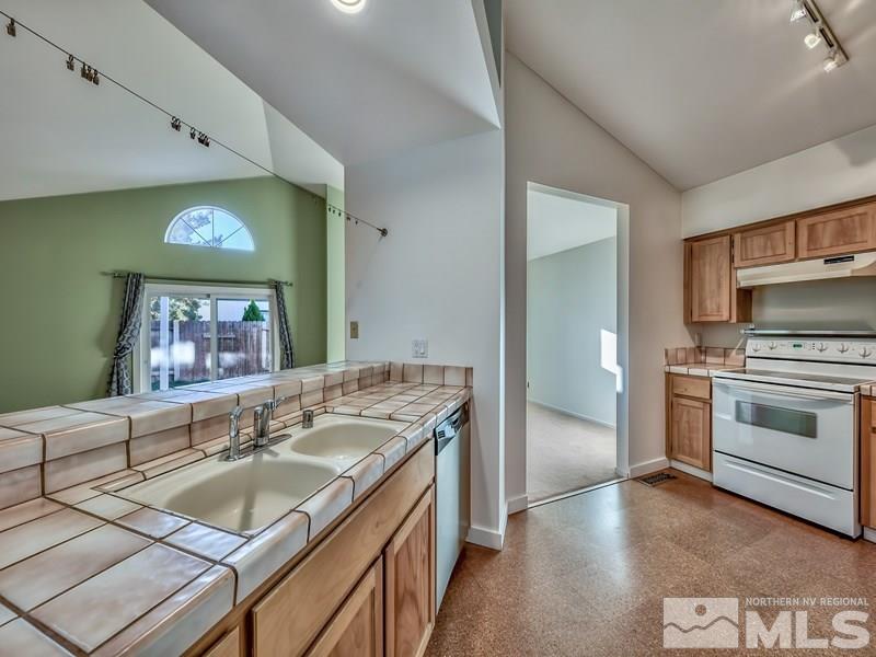 2301 Cordilla Court Reno, NV 89523 - Photo 8 of 18 a kitchen with a sink stove and cabinets