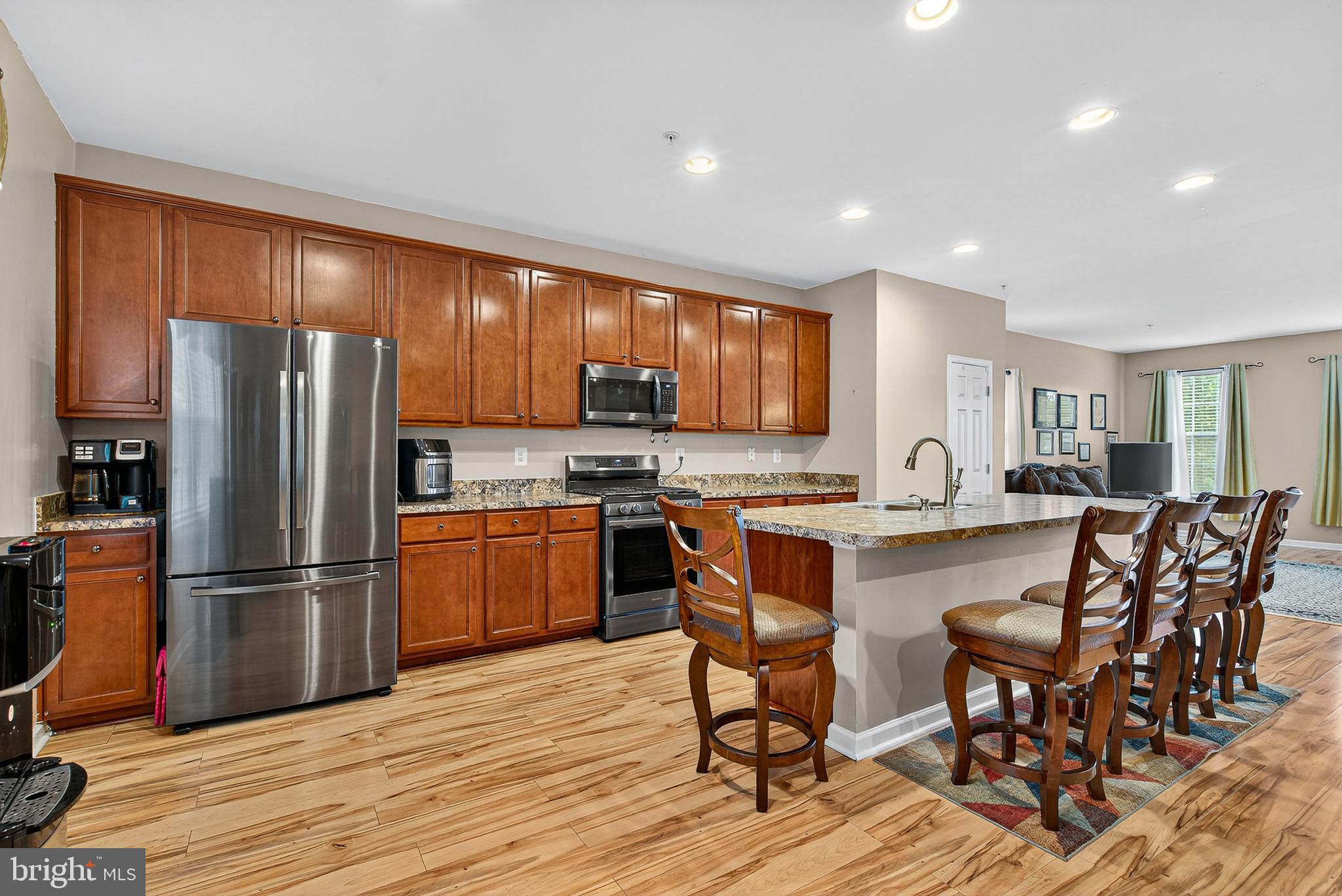 671 English Ivy Way Aberdeen, MD 21001 - Photo 4 of 30 a kitchen with stainless steel appliances granite countertop a refrigerator stove microwave and sink