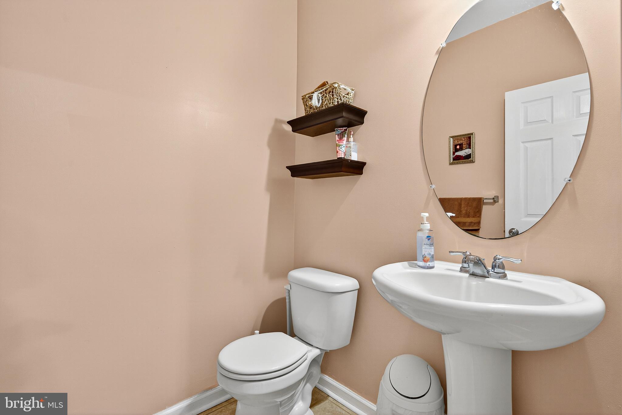 671 English Ivy Way Aberdeen, MD 21001 - Photo 9 of 30 a bathroom with a toilet sink and mirror