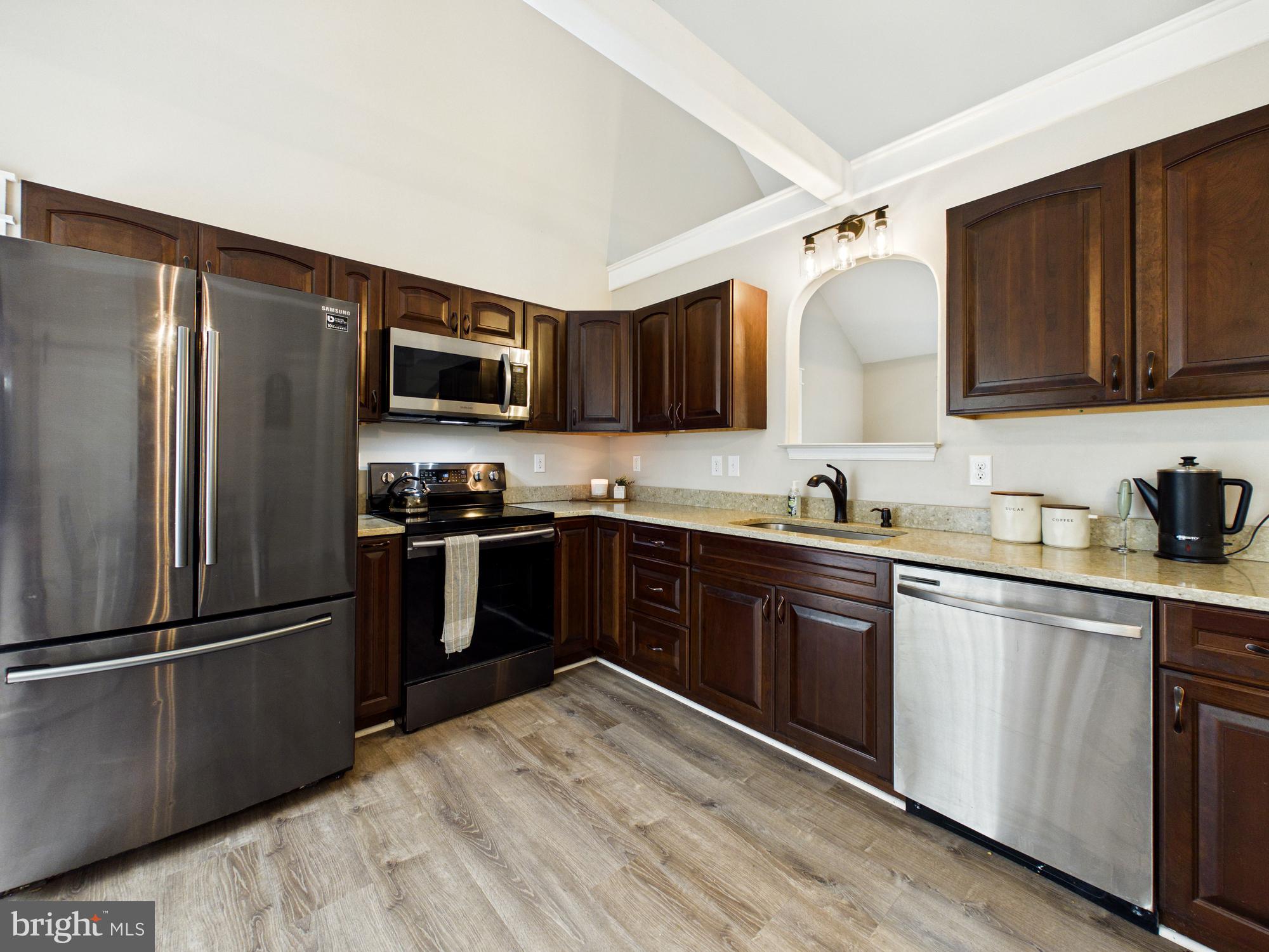 25095 Trunk Line Road Henderson, MD 21640 - Photo 6 of 39 Modern kitchen with rich wood tones.