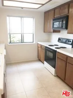 a kitchen with a stove and a microwave